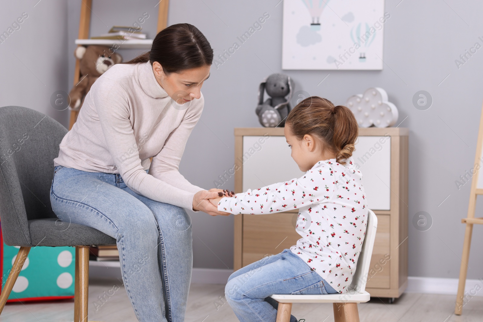 Photo of Resentful little girl and her mother at home