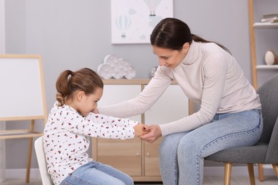 Photo of Resentful little girl and her mother at home