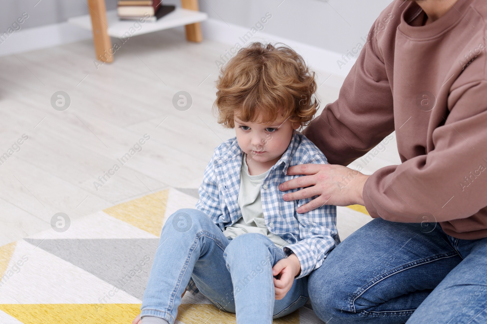 Photo of Resentful little boy and his father at home, space for text. Family dispute