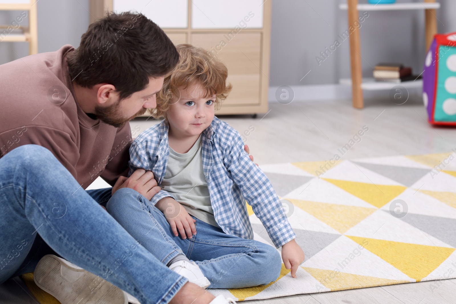 Photo of Resentful little boy and his father at home, space for text. Family dispute