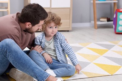 Photo of Resentful little boy and his father at home, space for text. Family dispute