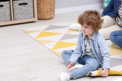 Photo of Resentful little boy and his parents at home, space for text. Family dispute