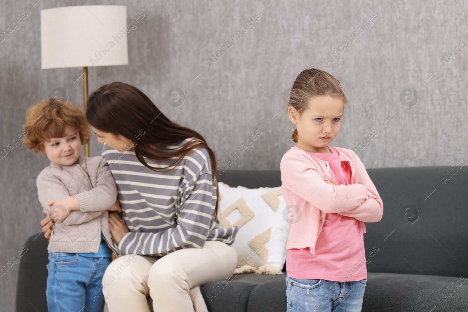 Photo of Resentful little kids and their mother arguing at home