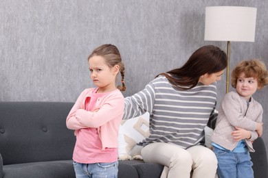 Photo of Resentful little kids and their mother arguing at home