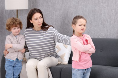 Photo of Resentful little kids and their mother arguing at home