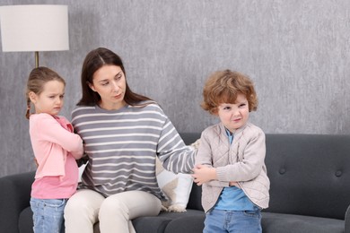 Photo of Resentful little kids and their mother arguing at home