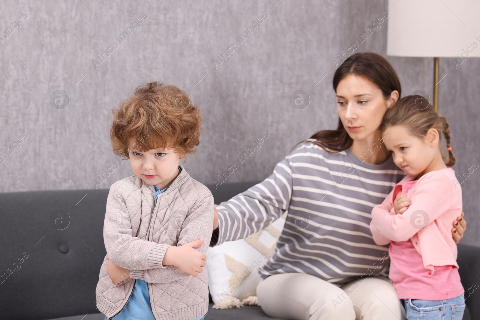 Photo of Resentful little kids and their mother arguing at home