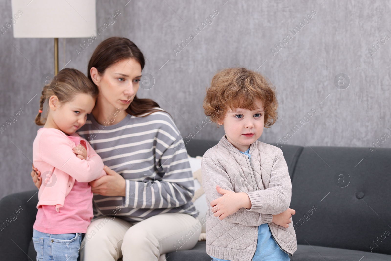 Photo of Resentful little kids and their mother arguing at home