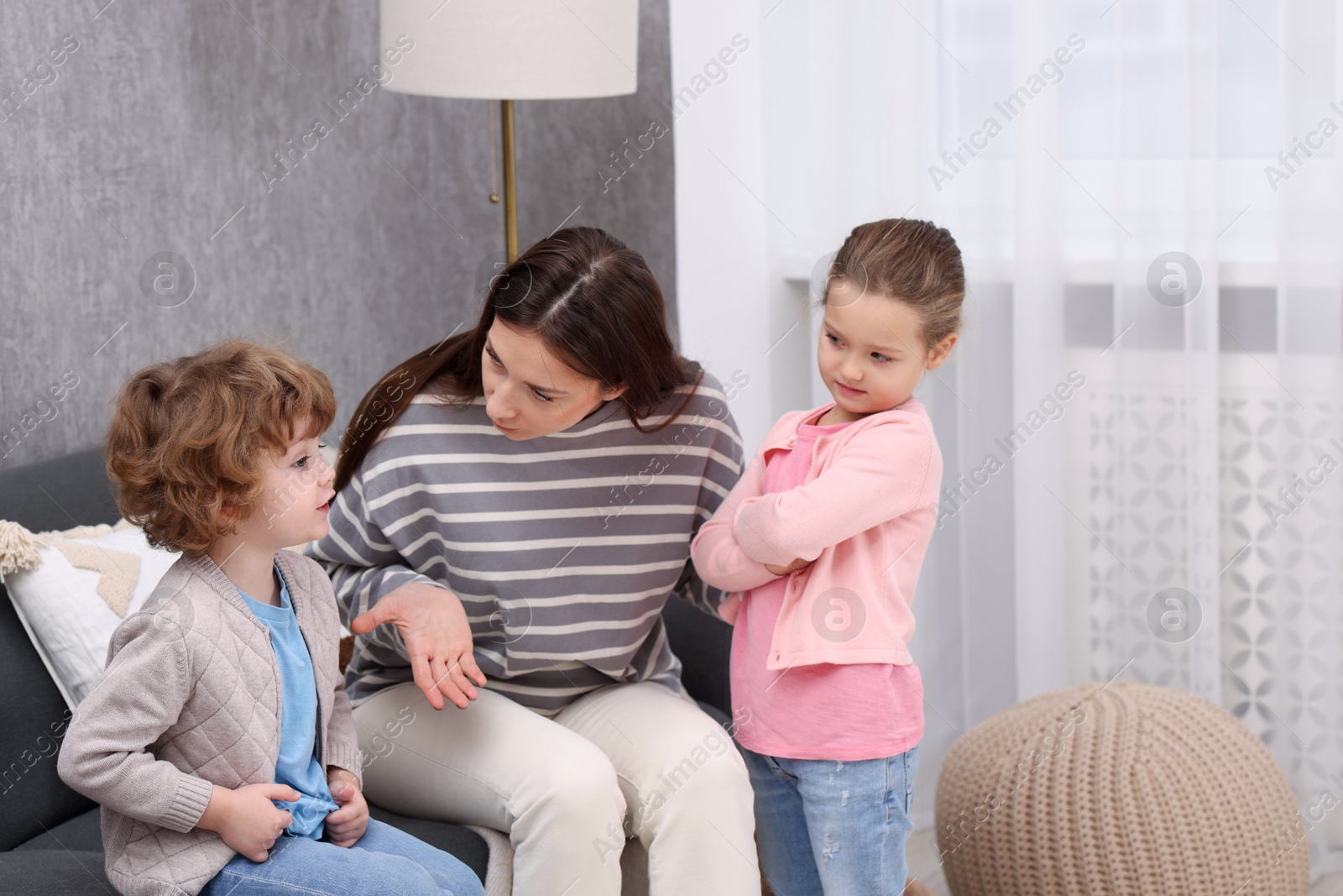 Photo of Resentful little kids and their mother arguing at home