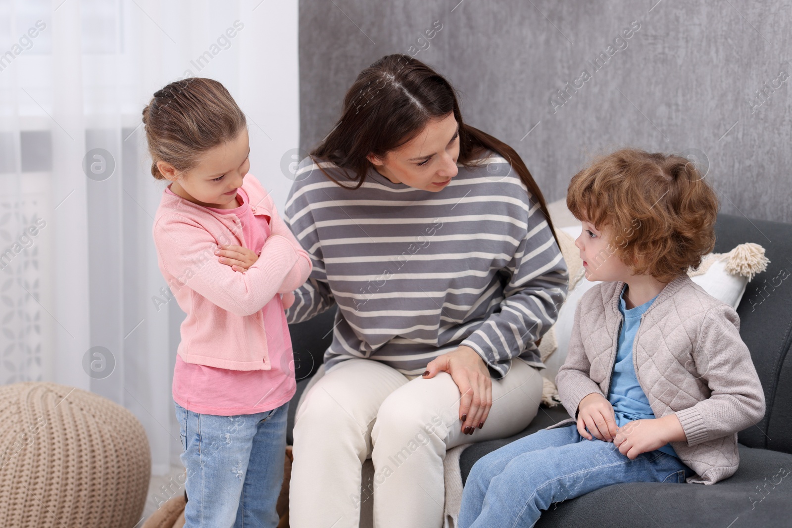 Photo of Resentful little kids and their mother arguing at home