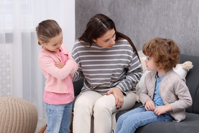 Photo of Resentful little kids and their mother arguing at home