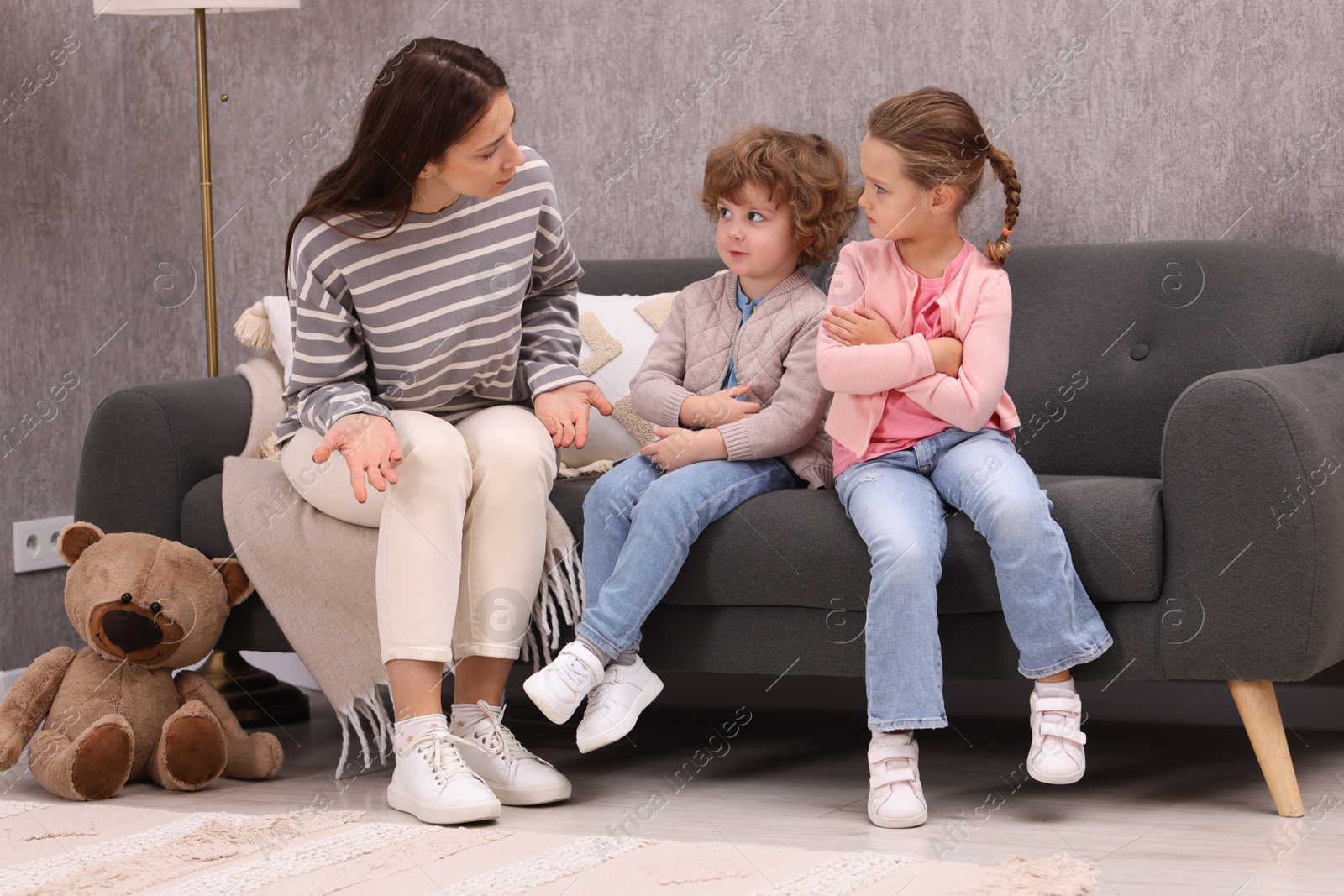 Photo of Resentful little kids and their mother arguing at home