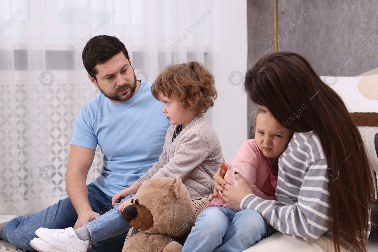 Photo of Resentful little kids and their parents arguing at home