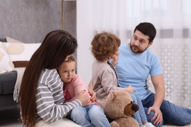 Photo of Resentful little kids and their parents arguing at home