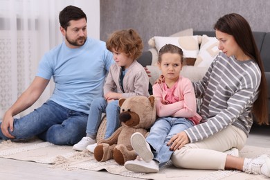 Photo of Resentful little kids and their parents arguing at home