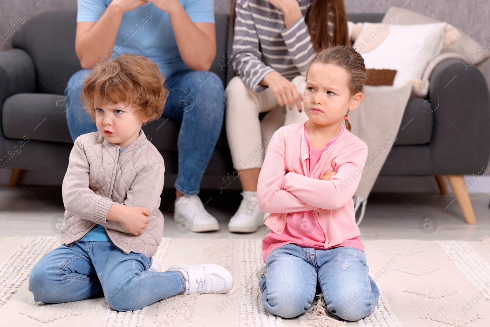 Photo of Resentful little kids and their parents arguing at home