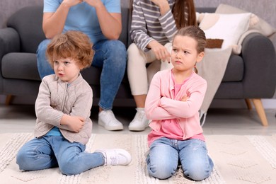 Photo of Resentful little kids and their parents arguing at home