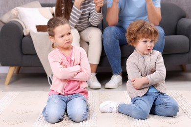 Photo of Resentful little kids and their parents arguing at home