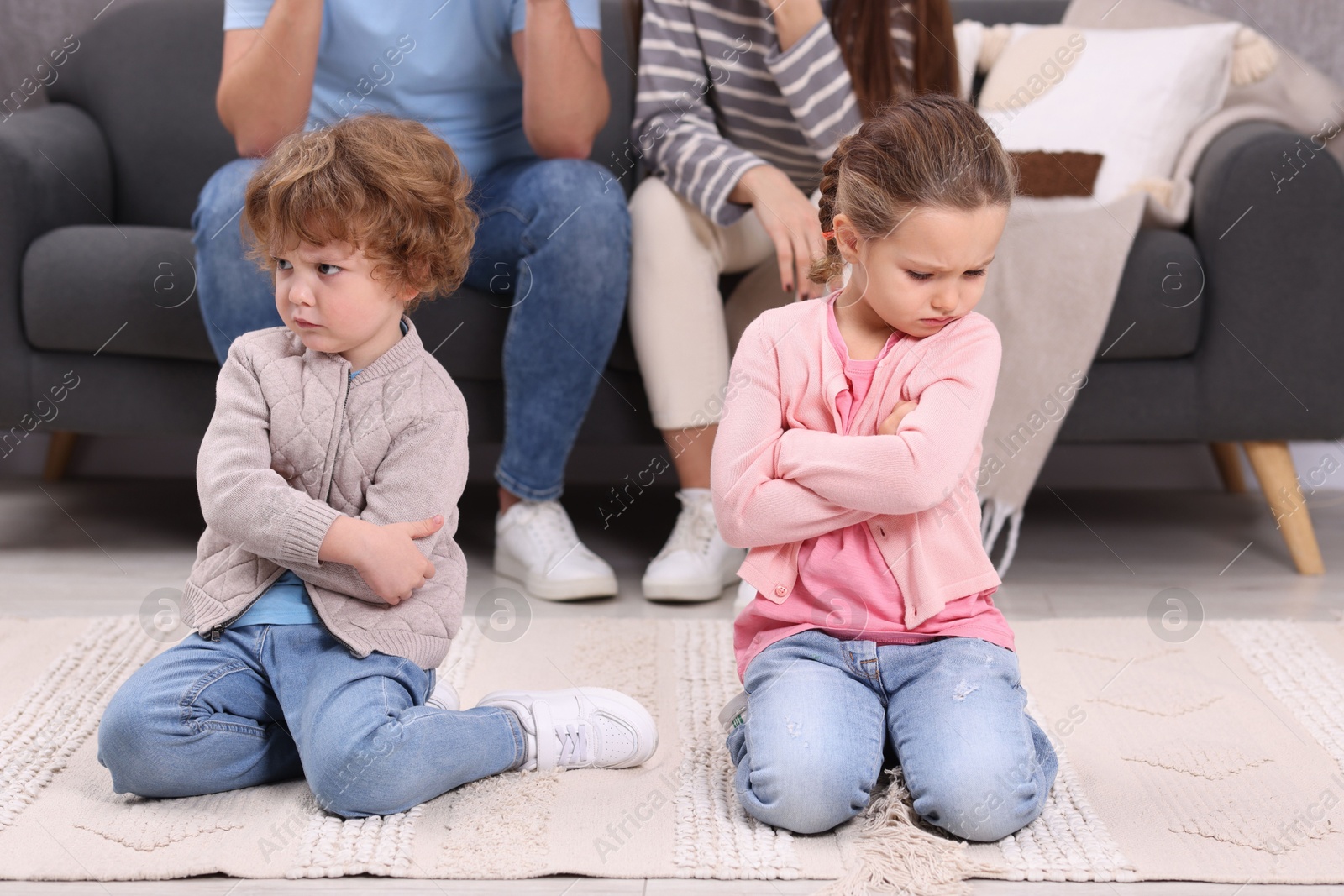 Photo of Resentful little kids and their parents arguing at home