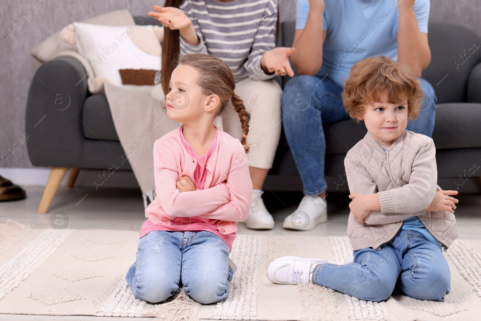 Photo of Resentful little kids and their parents arguing at home