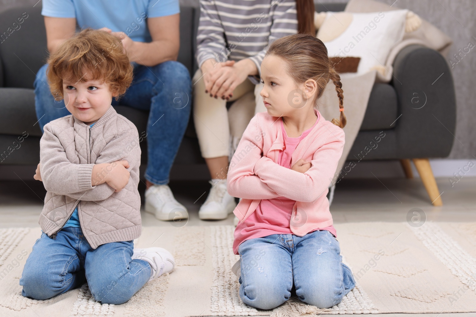 Photo of Resentful little kids and their parents arguing at home