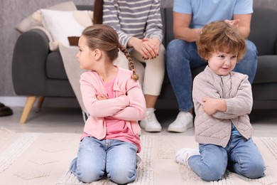 Photo of Resentful little kids and their parents arguing at home