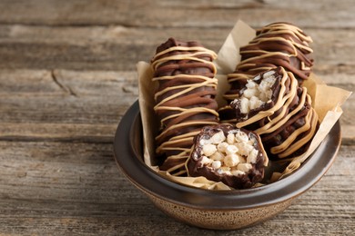 Photo of Delicious chocolate puffed rice bars on wooden table, closeup