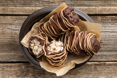 Photo of Delicious chocolate puffed rice bars on wooden table, top view