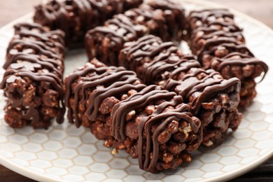 Photo of Delicious chocolate puffed rice bars on table, closeup