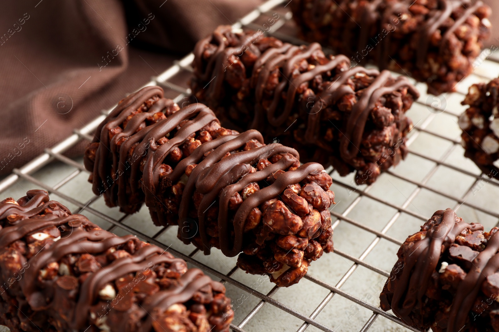 Photo of Delicious chocolate puffed rice bars on gray table, closeup