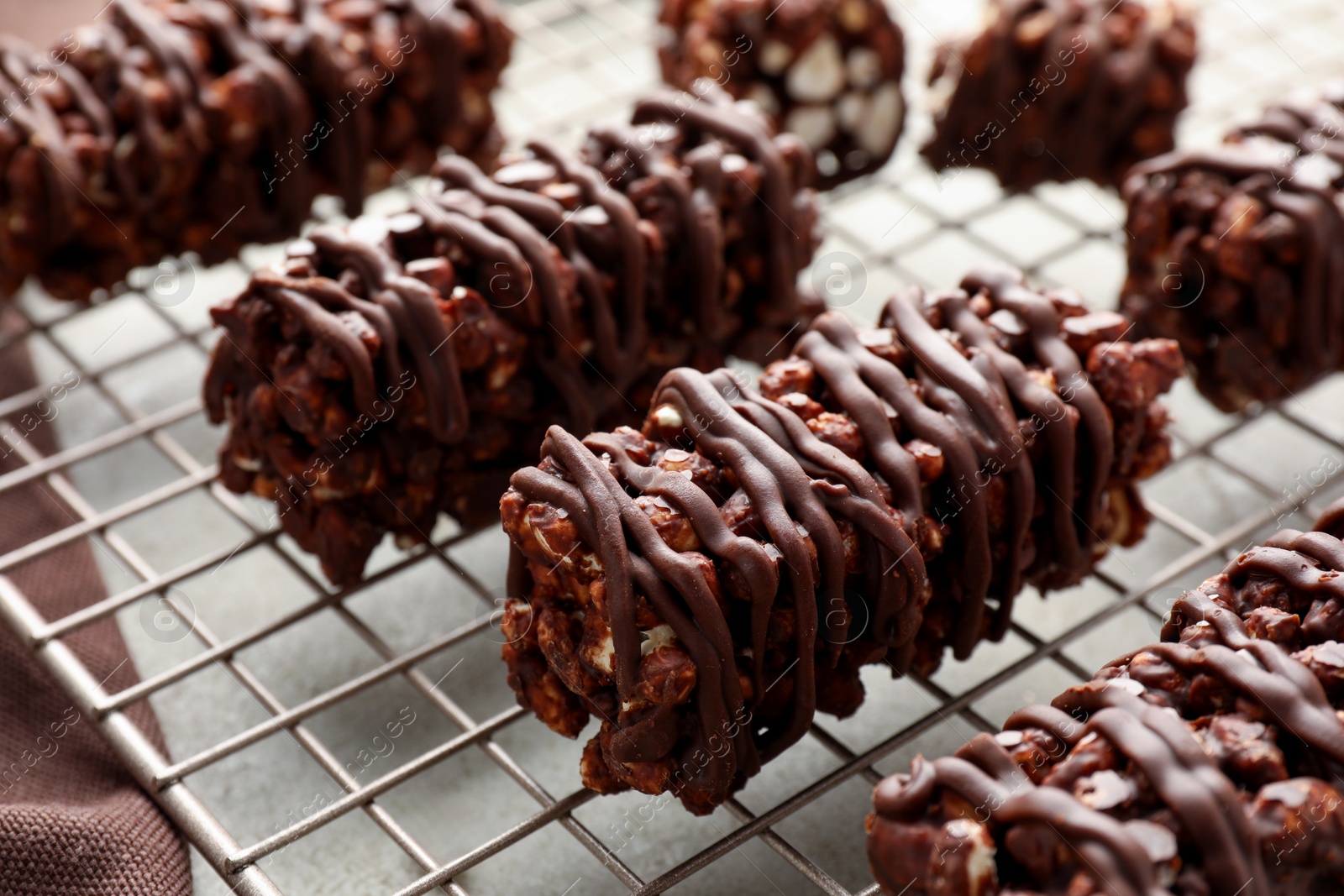 Photo of Delicious chocolate puffed rice bars on gray table, closeup