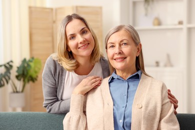 Photo of Family portrait of smiling mother and her daughter at home