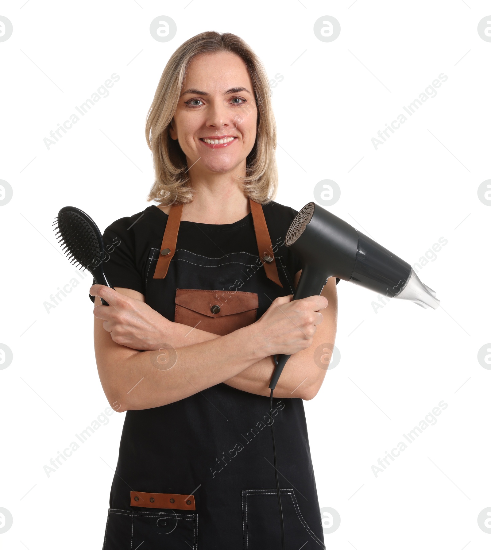 Photo of Smiling hairdresser with brush and dryer on white background