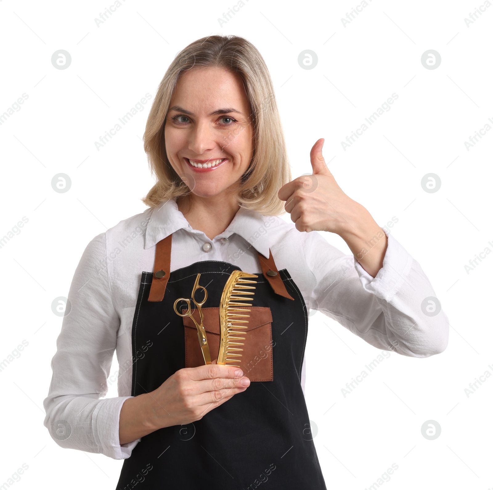 Photo of Smiling hairdresser with comb and scissors showing thumbs up on white background