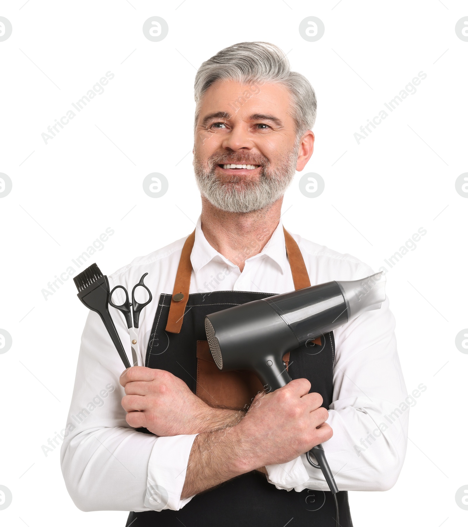 Photo of Smiling hairdresser with dryer, scissors and hair dye brush on white background