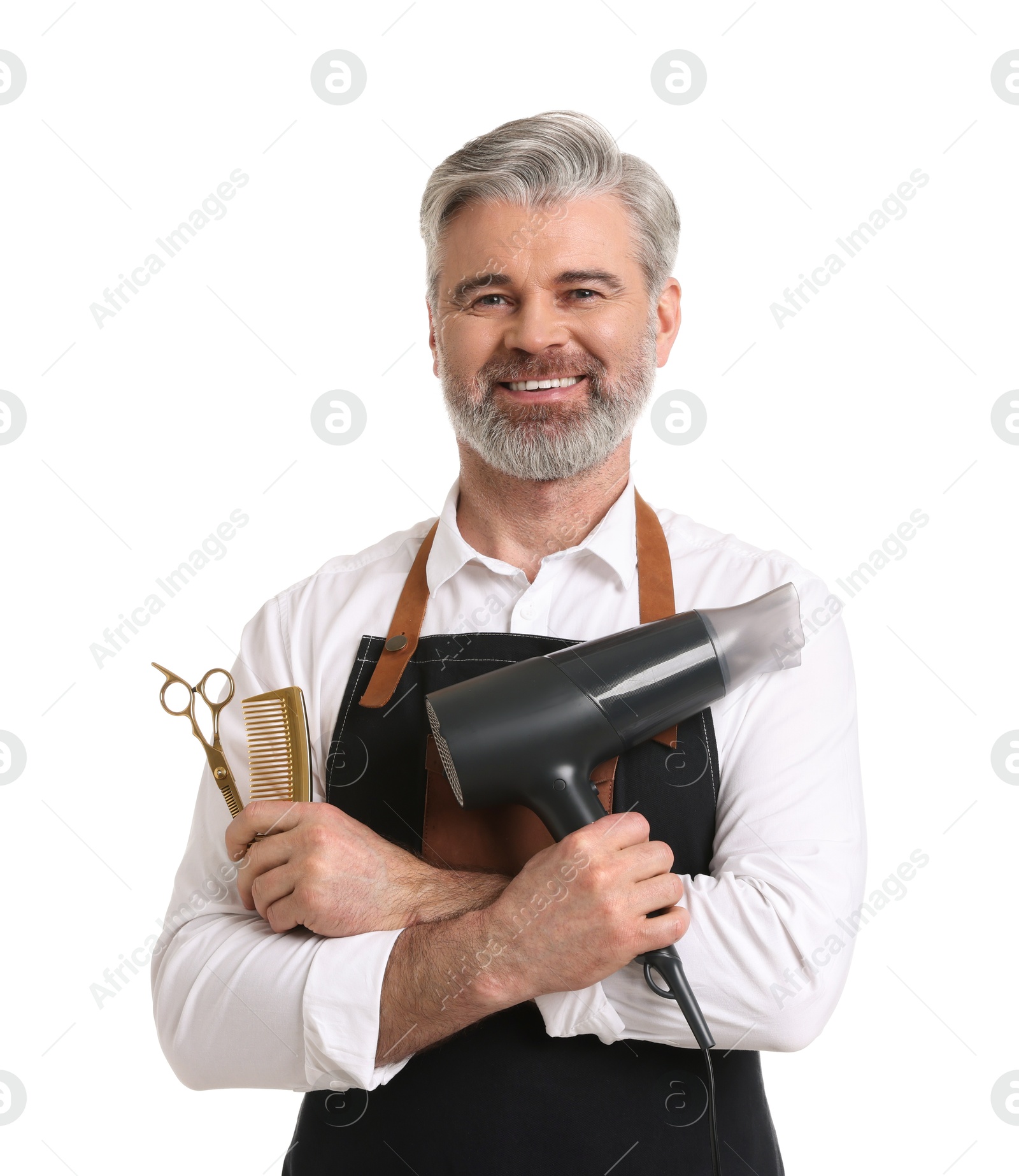 Photo of Smiling hairdresser with dryer, comb and scissors on white background