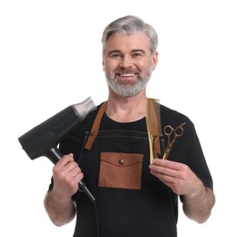 Photo of Smiling hairdresser with dryer, comb and scissors on white background