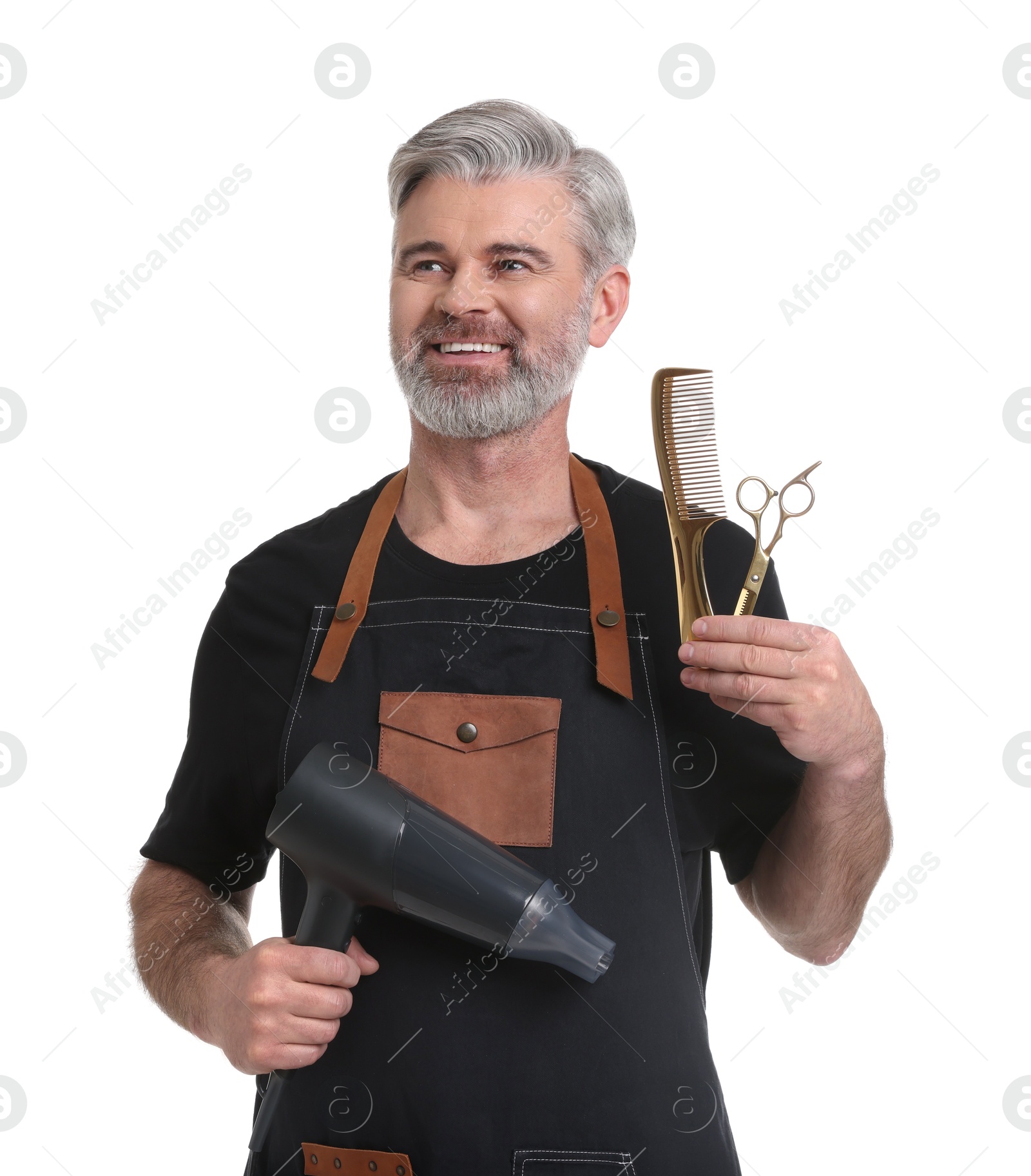 Photo of Smiling hairdresser with dryer, comb and scissors on white background