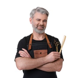 Photo of Smiling hairdresser with comb and scissors on white background