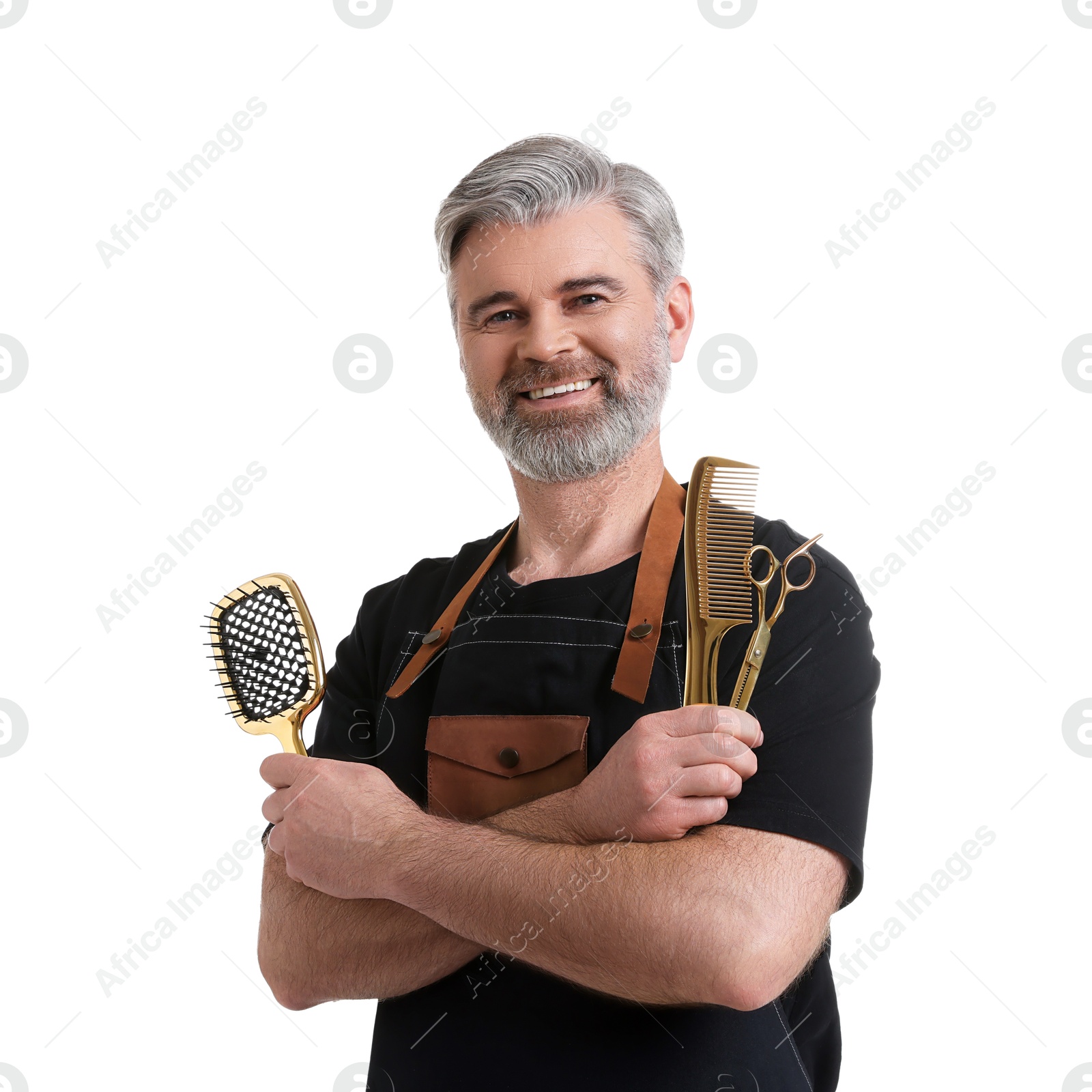 Photo of Smiling hairdresser with brush, comb and scissors on white background