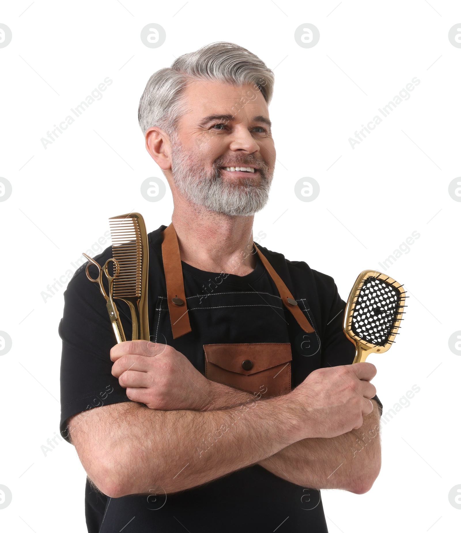 Photo of Smiling hairdresser with brush, comb and scissors on white background