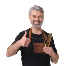 Photo of Smiling hairdresser with comb and scissors showing thumbs up on white background