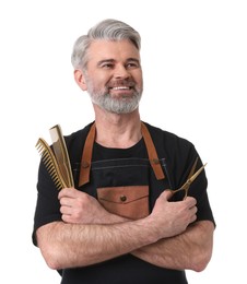 Photo of Smiling hairdresser with combs and scissors on white background