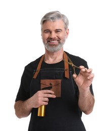 Photo of Smiling hairdresser with scissors and spray bottle on white background