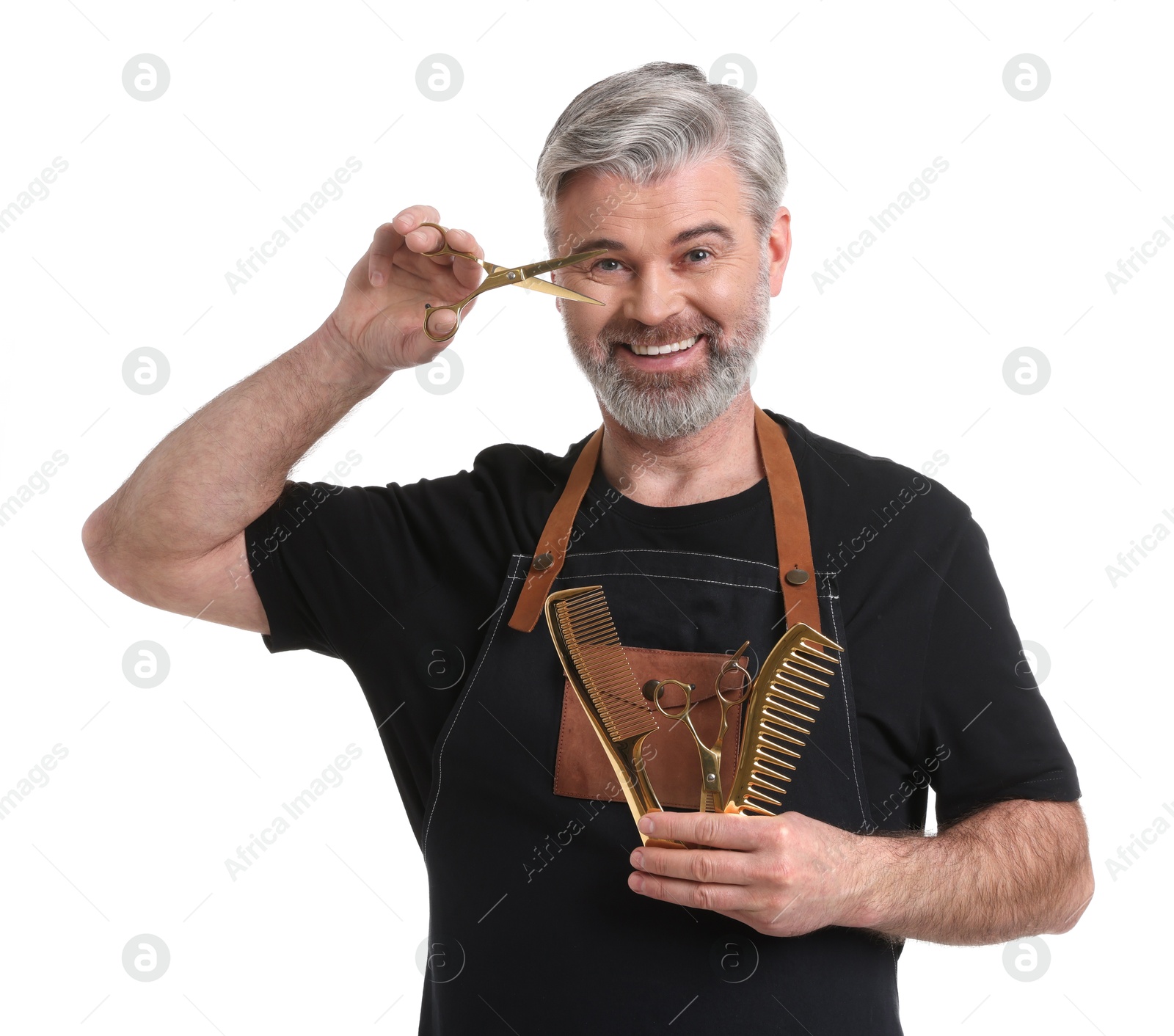 Photo of Smiling hairdresser with scissors and combs on white background