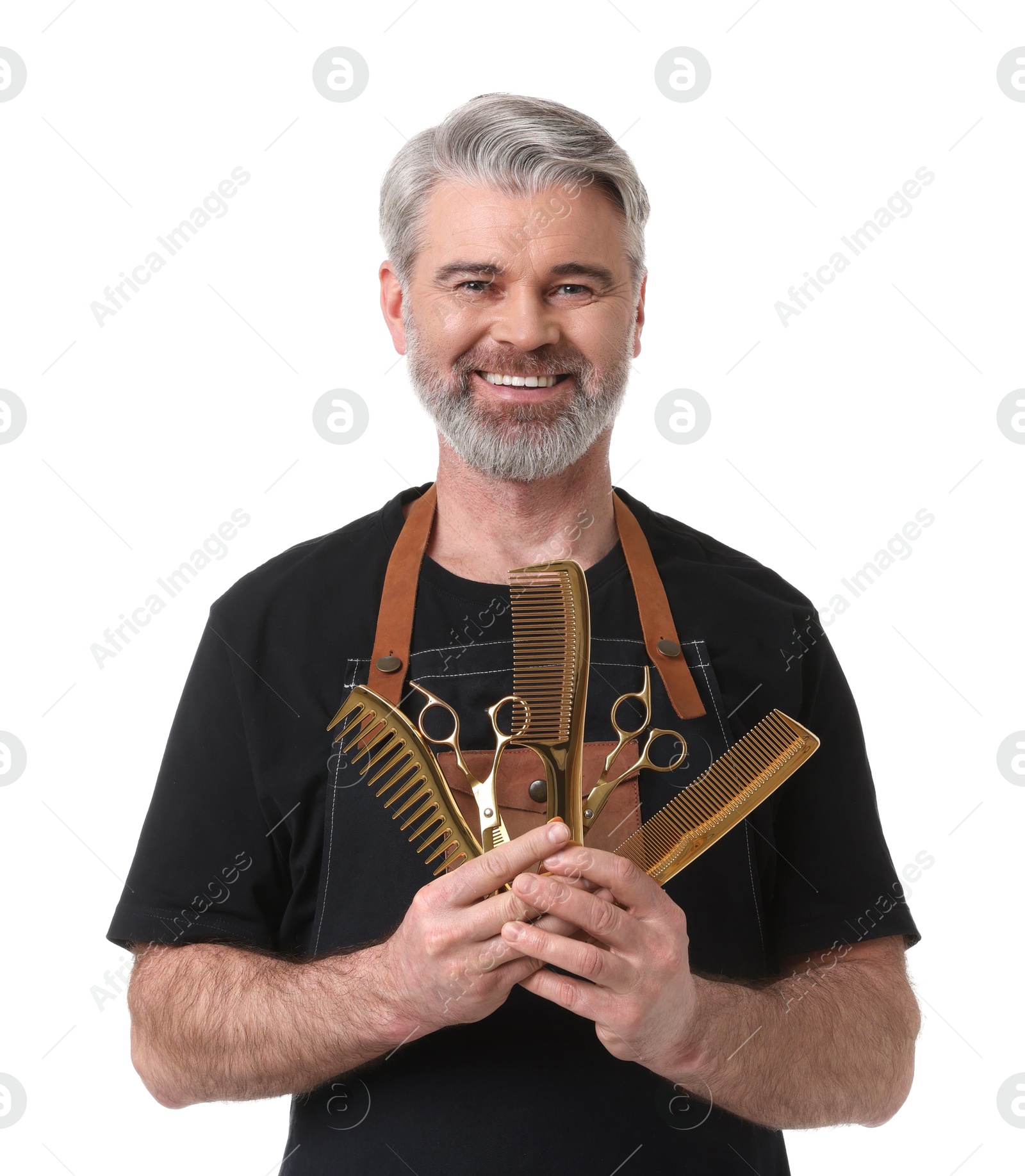 Photo of Smiling hairdresser with scissors and combs on white background