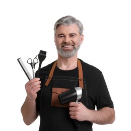 Photo of Smiling hairdresser with dryer, scissors, hair dye brush and comb on white background