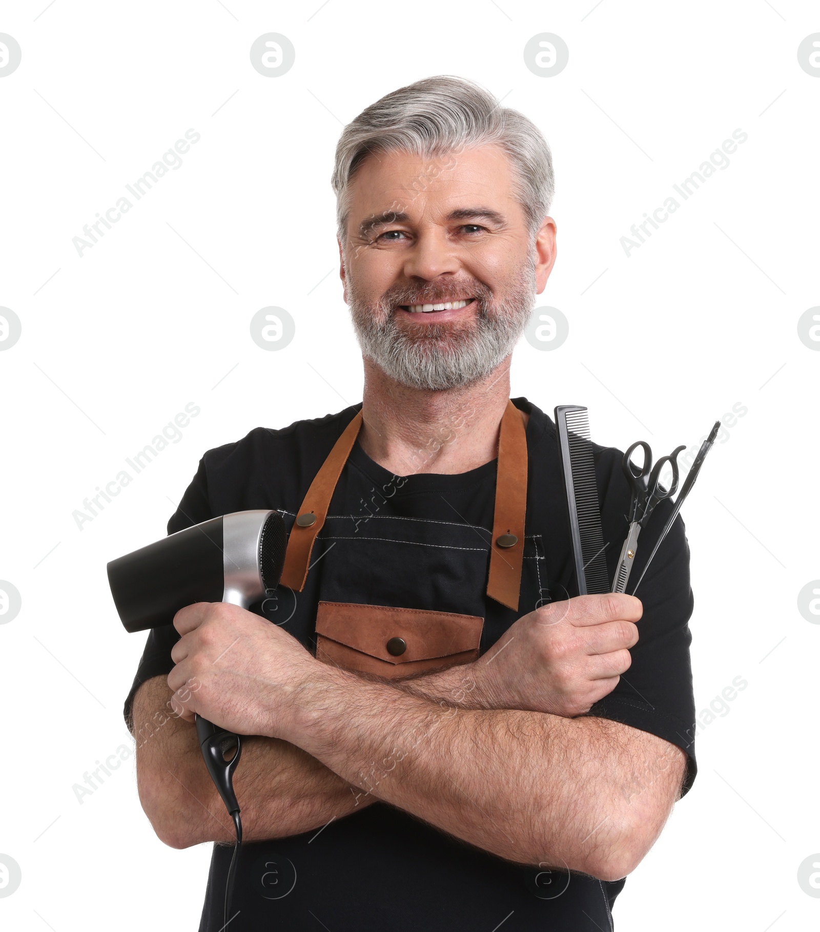 Photo of Smiling hairdresser with dryer, scissors, hair dye brush and comb on white background