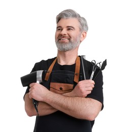 Photo of Smiling hairdresser with dryer, scissors, hair dye brush and comb on white background