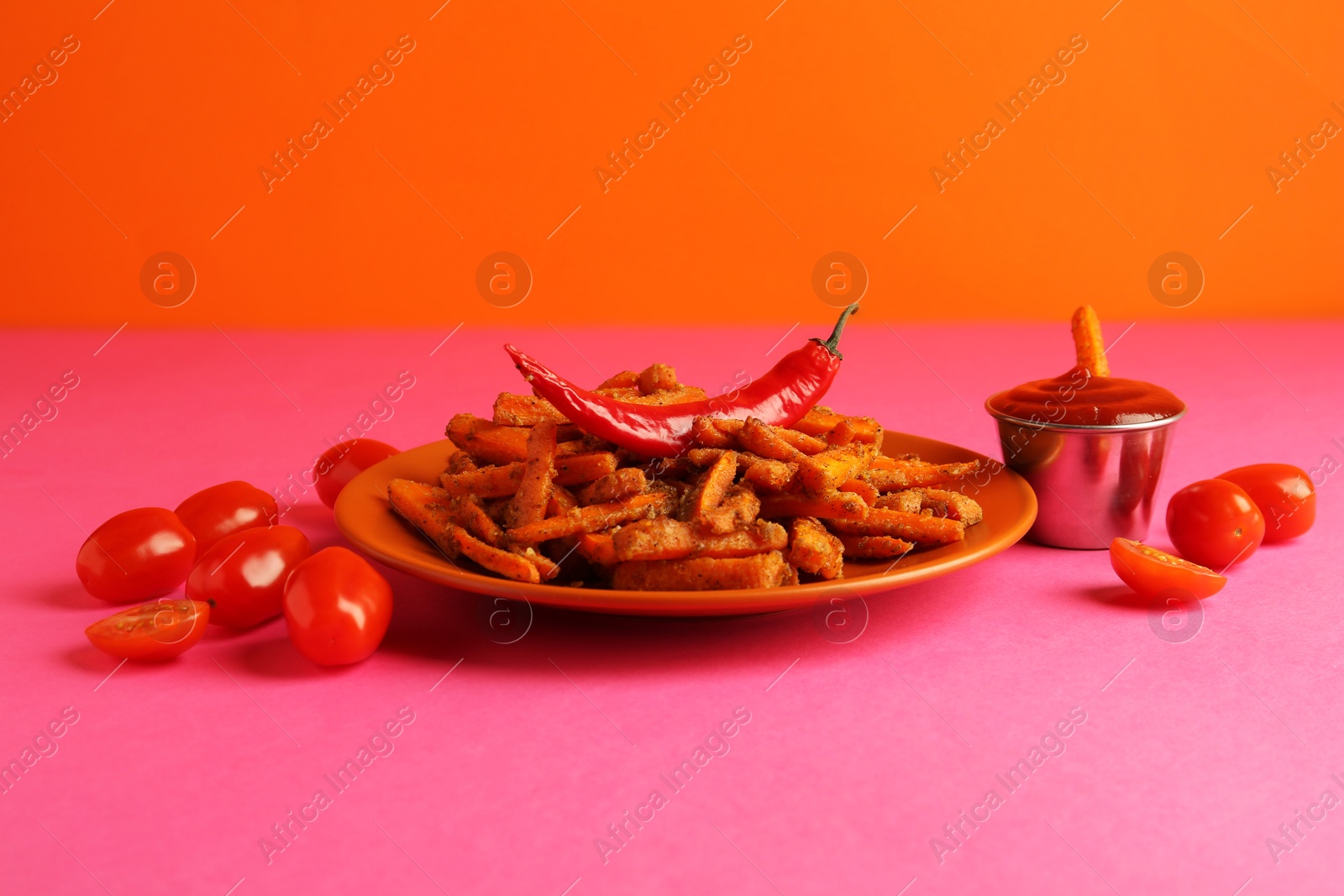 Photo of Tasty ketchup, tomatoes and fried carrots on color background